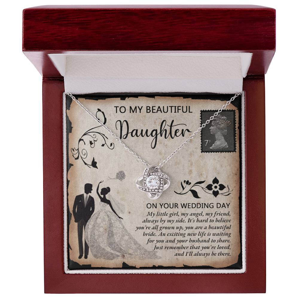 A silver To Daughter Wedding, Beautiful Bride - Love Knot Necklace adorned with cubic zirconia crystals on a card featuring an illustrated bride and groom. The card reads "To my beautiful daughter on your wedding day" with a heartfelt message.