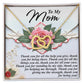 The Mom-Being You - Interlocking Hearts Necklace in a rose gold finish rests on a floral-designed card that reads, "To My Mom," expressing gratitude for her help, support, and love, and thanking her for being a strength source.