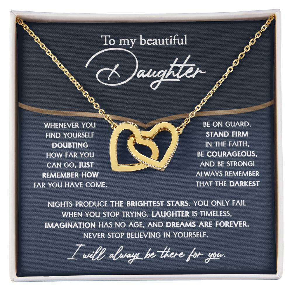 The "To Daughter, Brightest Stars - Interlocking Hearts Necklace," crafted from high-quality polished surgical steel and adorned with cubic zirconia crystals, is presented on a message card addressed to a daughter, offering encouraging and motivational words.