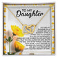 The Daughter-Journey Home Interlocking Hearts Necklace, embellished with cubic zirconia, is elegantly housed in a floral gift box with heartfelt messages from a parent to their daughter, expressing love and wishes for her safety and happiness.
