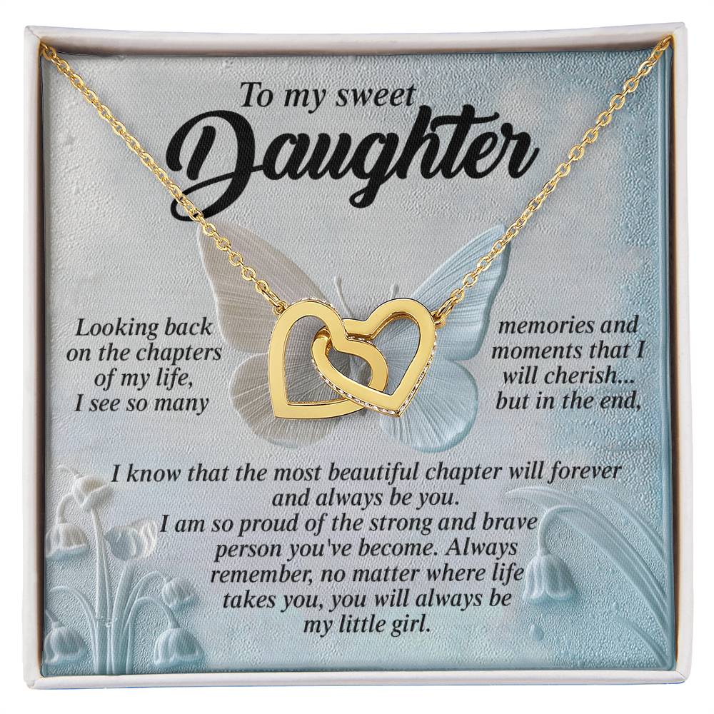 The Daughter-Beautiful Chapter jewelry box includes an Interlocking Hearts necklace with cubic zirconia crystals, set against a butterfly background. The inscription expresses love, pride, and cherished memories between a daughter and her family.