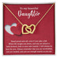 Introducing the elegant "To Daughter, As You Are 2 - Interlocking Hearts Necklace." This stunning piece features two intertwined hearts set against a red background and adorned with sparkling cubic zirconia crystals. The pendant holds the heartfelt message: "To my beautiful Daughter. Stand proud and tall, even if you take a fall..." Crafted from durable surgical steel, this necklace is designed to be both beautiful and enduring.