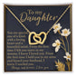 The Daughter-One Kind - Interlocking Hearts Necklace, adorned with cubic zirconia crystals and presented in a box, is set against a black floral-accented background featuring the text "To my Daughter," followed by a heartfelt message expressing love and appreciation.