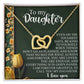 The "Daughter-Tough Days - Interlocking Hearts Necklace" comes in a gift box featuring rose gold finish hearts adorned with cubic zirconia crystals. The text reads: "To my Daughter... Even on the toughest days, be kind to yourself... I'm forever grateful to call you my daughter. I love you." Decorated with yellow flowers.