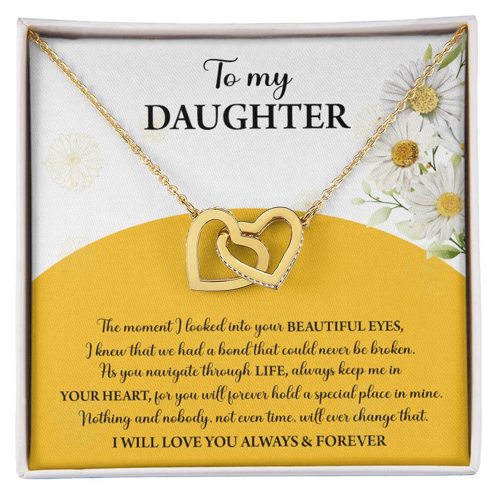 A box contains a "To Daughter, A Special Place - Interlocking Hearts Necklace" with cubic zirconia crystals. The message reads: "To my Daughter... Always keep me in your heart... Nothing brings me more joy than you. I will love you always & forever.