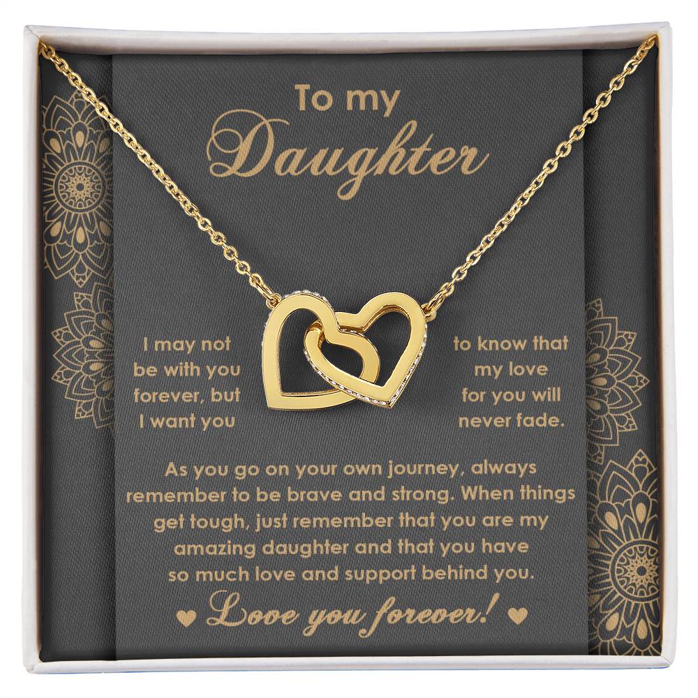 The "To Daughter, Brave And Strong 2 - Interlocking Hearts Necklace" features high-quality polished surgical steel and sparkling cubic zirconia crystals. It is presented on a card adorned with an inspiring message for your daughter, expressing love and encouragement.