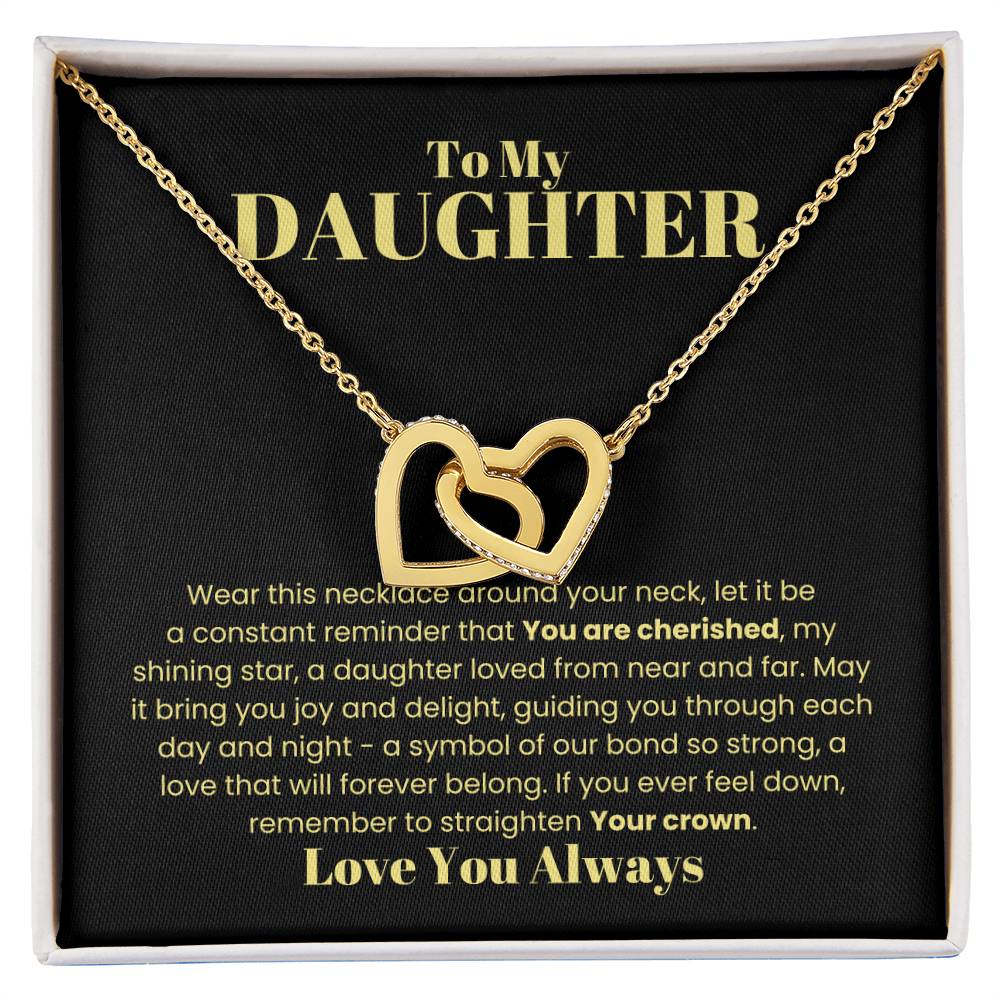 The '[Almost Sold Out] To My Daughter, Wear This Necklace - Interlocking Hearts Necklace' features a gold heart-shaped pendant with an intertwined design adorned with glistening cubic zirconia crystals on a card symbolizing never-ending love with its interlocking hearts and heartfelt message.