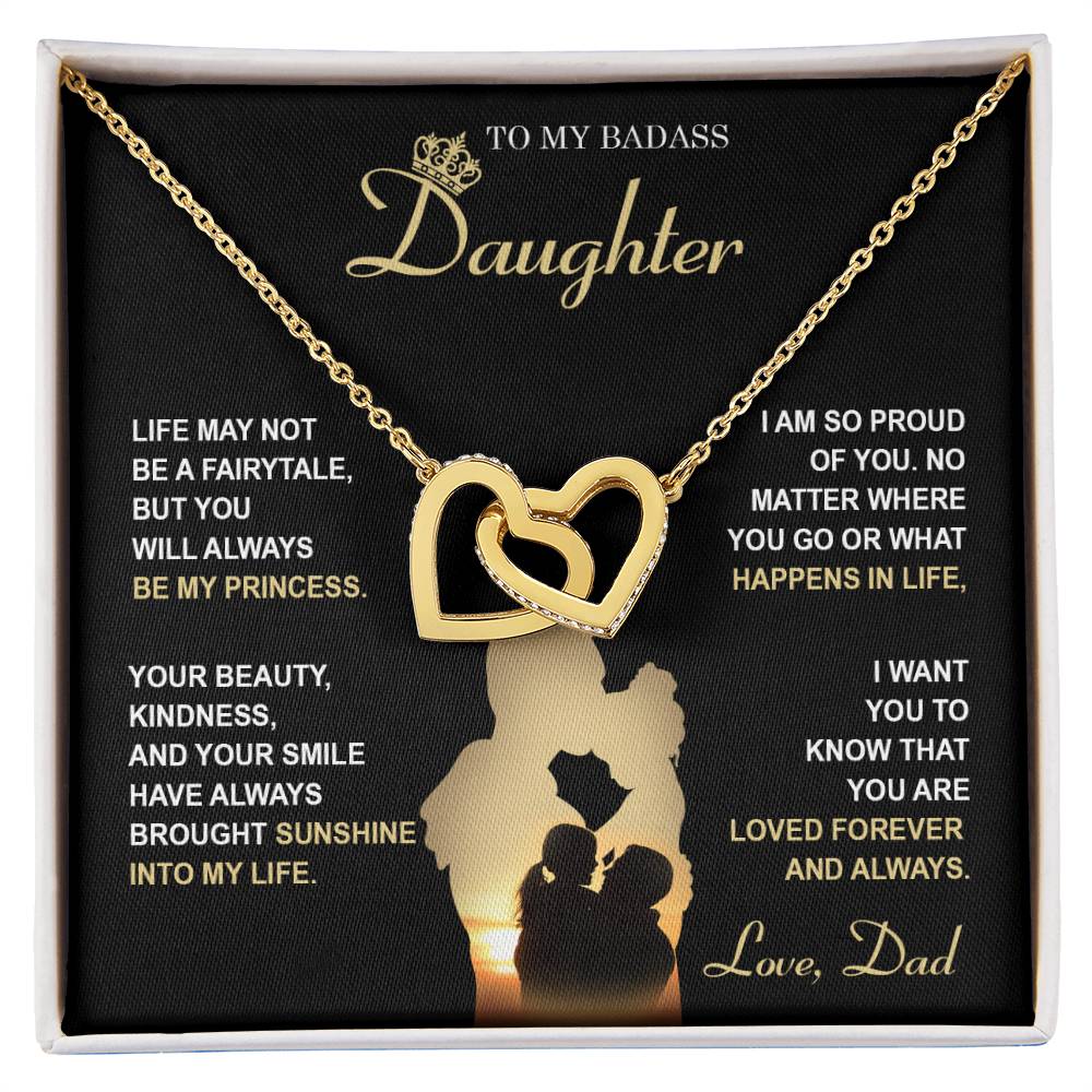 The "To Daughter, Be My Princess - Interlocking Hearts Necklace" with a rose gold finish and adorned with cubic zirconia crystals is displayed in a box that features a heartfelt message from a father to his daughter about love, support, and pride. The text and silhouette of a father and daughter are also included below.