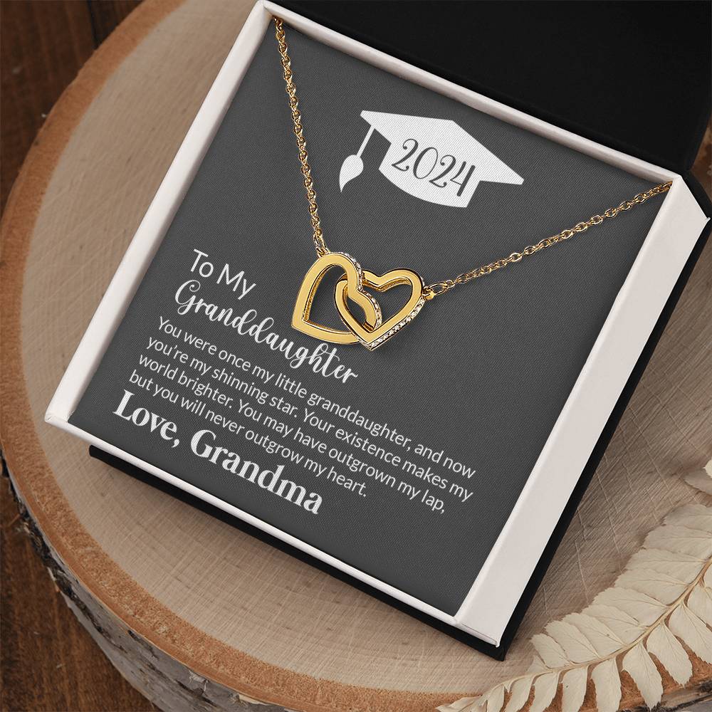 A heart-shaped gold pendant necklace with Cubic Zirconia Crystals in a gift box, featuring a sentimental message from ShineOn Fulfillment for a granddaughter from a grandmother.