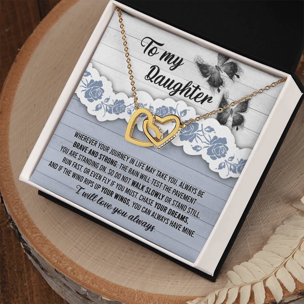 The "To Daughter, Always Have Mine - Interlocking Hearts Necklace," adorned with cubic zirconia crystals, is beautifully presented against a decorative card that inspires bravery, strength, and the pursuit of dreams. The message is addressed "To my Daughter" and concludes with "I will love you always.