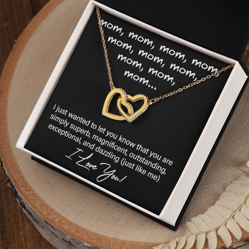 The "To Mom, Just Like Me" Interlocking Hearts Necklace, adorned with cubic zirconia crystals, comes in a black gift box and features a heartfelt message expressing admiration for "mom" and declaring "I love you.