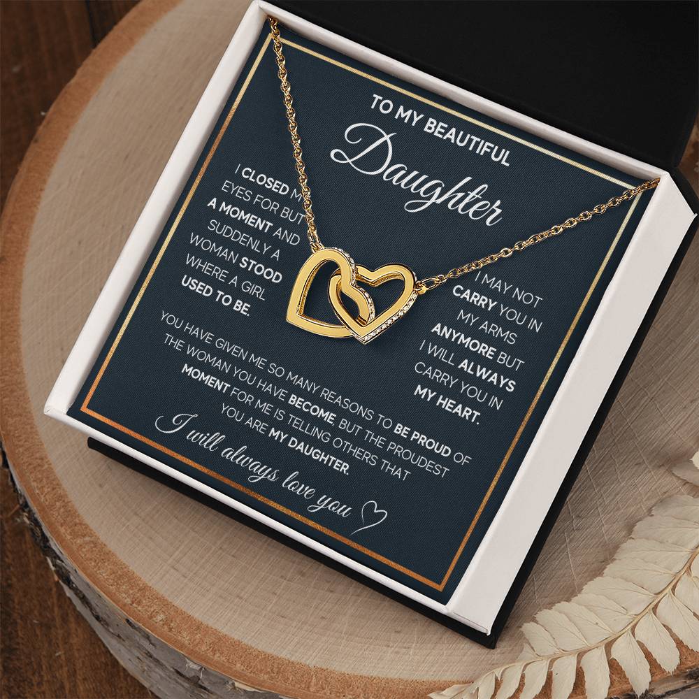Replace sentence: A heart-shaped interlocking hearts necklace pendant with Cubic Zirconia crystals inside a gift box with a sentimental message from ShineOn Fulfillment.