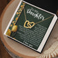 The Daughter-Tough Days gift box features a rose gold Interlocking Hearts necklace with cubic zirconia crystals. The lid showcases a heartfelt message for a daughter, surrounded by yellow tulips and daisies, encouraging resilience and expressing love and pride.