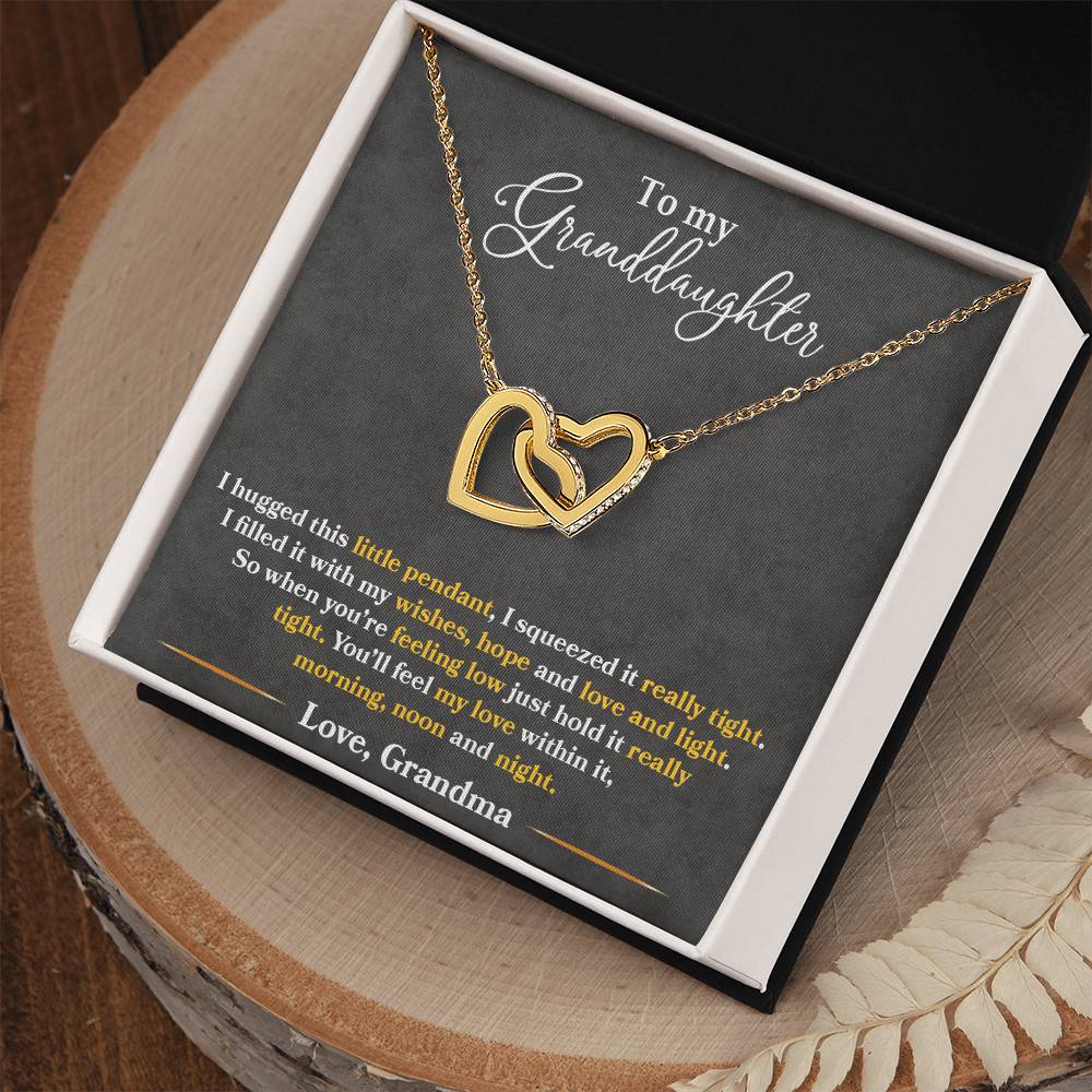 A gift box containing a "To My Granddaughter, You_ll Feel My Love Within This" - Interlocking Hearts Necklace from ShineOn Fulfillment and a loving note from grandma to her granddaughter.