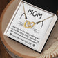 The "Cat Mom-When I'm Mean - Interlocking Hearts Necklace" features cubic zirconia crystals with a rose gold finish, packaged in a box decorated with cat ears and whiskers, saying: "MOM. Thank you for the food and catnip. You keep my litter box clean, even when I'm mean. Love, your purrfect cat.
