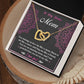 The Bonus Mom-An Amazing Mom Interlocking Hearts Necklace, with gold double hearts and cubic zirconia accents, is presented in an open black gift box. The card reads, "To My Bonus Mom," conveying love and gratitude amid a pink floral backdrop.