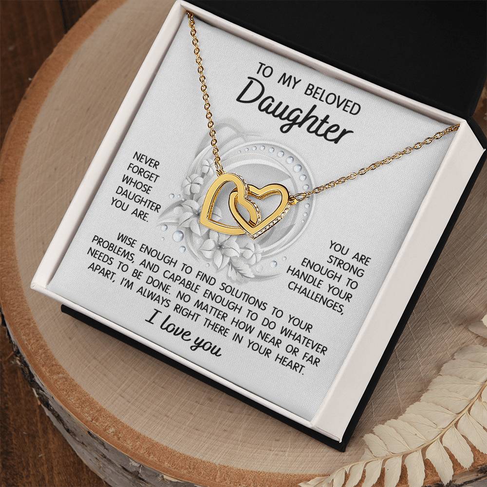 The "To Daughter, Always Right There - Interlocking Hearts Necklace" features a stunning interlocking hearts design with a rose gold finish and sparkling cubic zirconia crystals. It comes in a gift box that includes a heartfelt message for your beloved daughter, offering support, wisdom, and love.