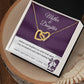 The Mother & Daughter-Never Truly Apart Interlocking Hearts Necklace, adorned with sparkling cubic zirconia, rests in a gift box. The card inside says "Mother & Daughter" and features a touching message about their bond.
