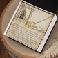 The Daughter-Withstand Storm - Interlocking Hearts Necklace in a rose gold finish is elegantly displayed in a box with a vintage ship illustration card, sharing a heartfelt message about bravery and remembrance against challenges, beautifully set on a wooden surface.