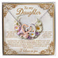 The Daughter-Heart Happiness necklace features silver interlocking heart pendants and is presented on a card decorated with flowers and a heartfelt message starting with "To my Daughter" and ending with "I believe in you.