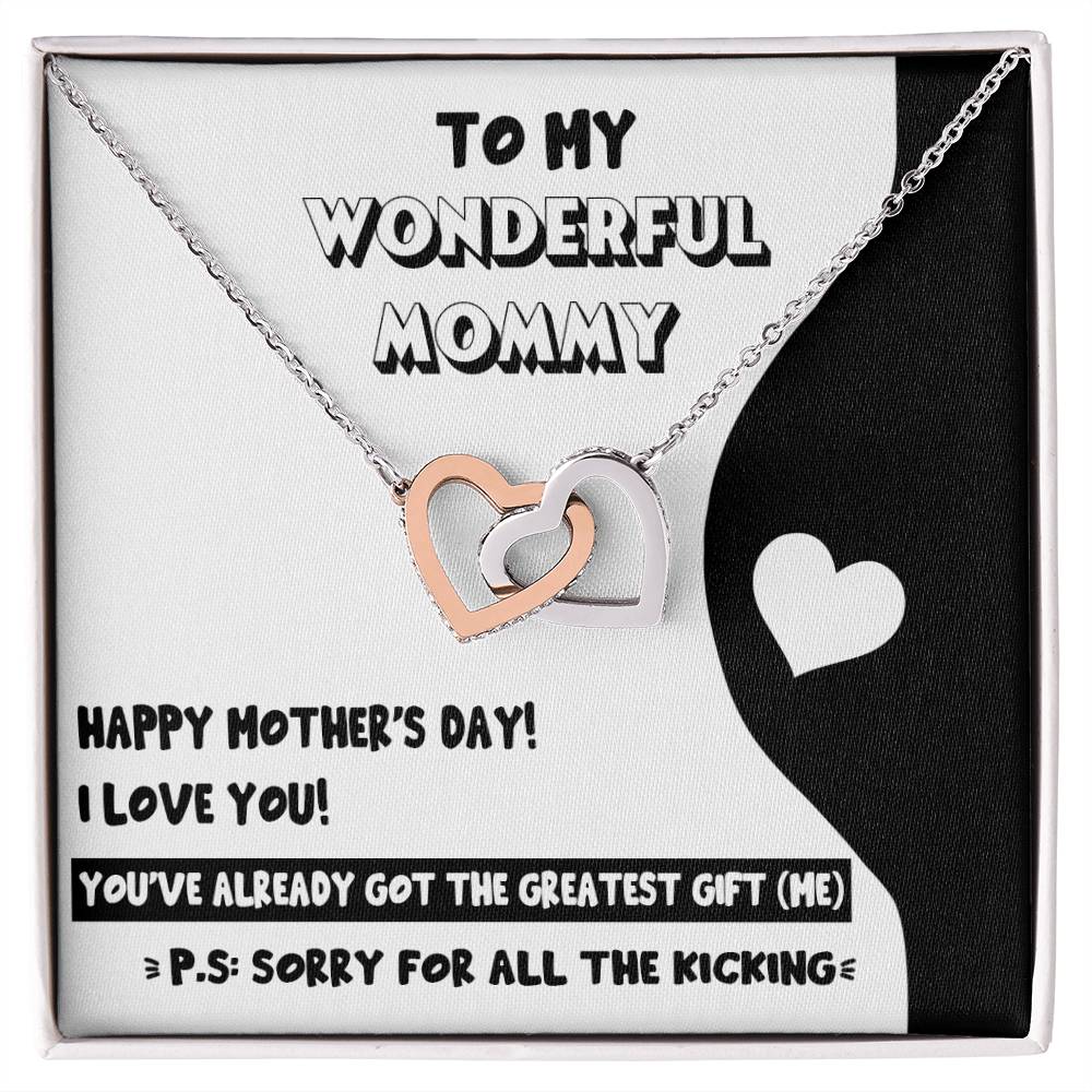 A mother's day gift display featuring a card with a heartfelt message and an "To Mom To Be, The Greatest Gift" interlocking hearts necklace adorned with Cubic Zirconia crystals by ShineOn Fulfillment.