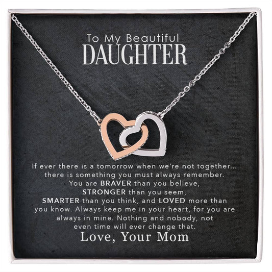 A To My Beautiful Daughter, You Are Braver Than You Believe - Interlocking Hearts Necklace from ShineOn Fulfillment, adorned with cubic zirconia crystals, displayed on a black background with a touching message from a mother to her daughter.