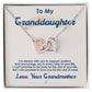 A silver and rose gold ShineOn Fulfillment Interlocking Hearts necklace pendant on a display card with a sentimental message from a grandmother to her granddaughter, designed as an anniversary gift.
