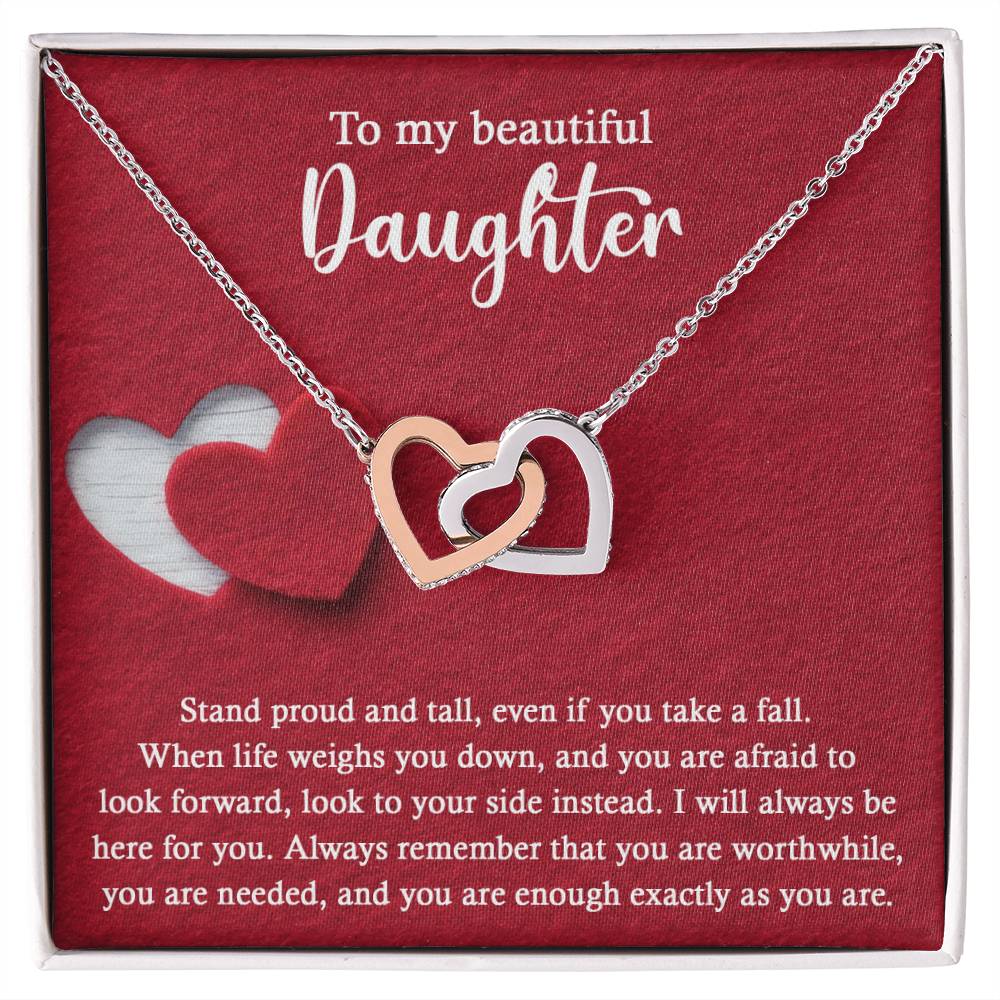 Introducing the elegant "To Daughter, As You Are 2 - Interlocking Hearts Necklace." This stunning piece features two intertwined hearts set against a red background and adorned with sparkling cubic zirconia crystals. The pendant holds the heartfelt message: "To my beautiful Daughter. Stand proud and tall, even if you take a fall..." Crafted from durable surgical steel, this necklace is designed to be both beautiful and enduring.