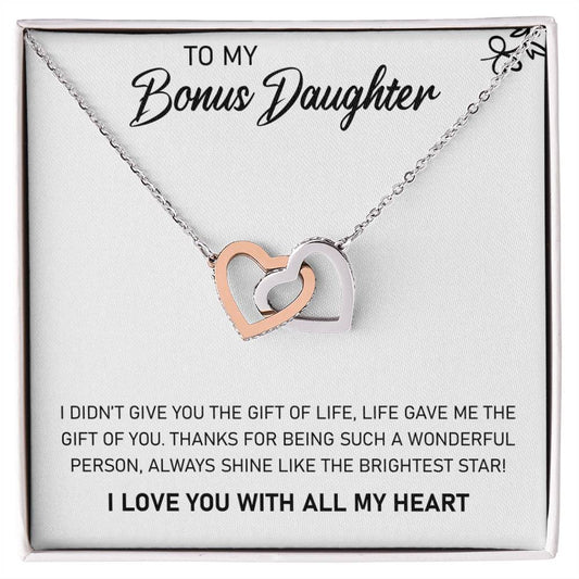 A To My Bonus Daughter, Always Shine Like The Brightest Star - Interlocking Hearts Necklace in a gift box with a message from ShineOn Fulfillment expressing gratitude and love.