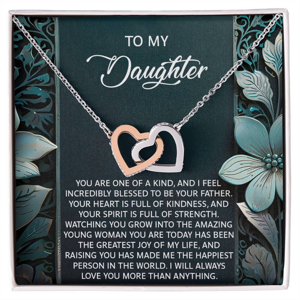 The Daughter-Happiest Person Interlocking Hearts Necklace features cubic zirconia crystals on a floral box. The text reads: To My Daughter. It's a heartfelt message of love and appreciation, beautifully enhanced by a rose gold finish.