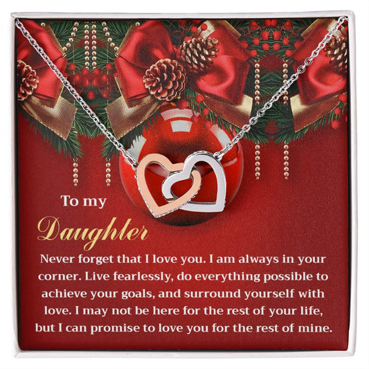 Presenting the exquisite Daughter-Achieve Your Goals - Interlocking Hearts Necklace, featuring a rose gold finish and adorned with dazzling cubic zirconia crystals. This beautiful piece is presented on a heartfelt message card for your daughter, accompanied by a Christmas-themed background complete with ornaments and greenery to enhance its festive charm.