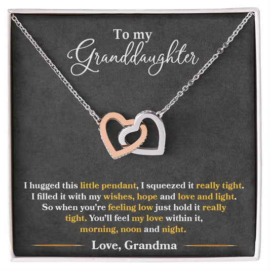 A To My Granddaughter, You_ll Feel My Love Within This - Interlocking Hearts Necklace from ShineOn Fulfillment, adorned with cubic zirconia crystals, presented on a card with a heartfelt message from a grandmother to her granddaughter.