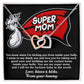 A necklace featuring a "To Mama To Be, My Super Mom" pendant laid on a black surface with a heartfelt thank-you message from an unborn baby to its mother by ShineOn Fulfillment.
