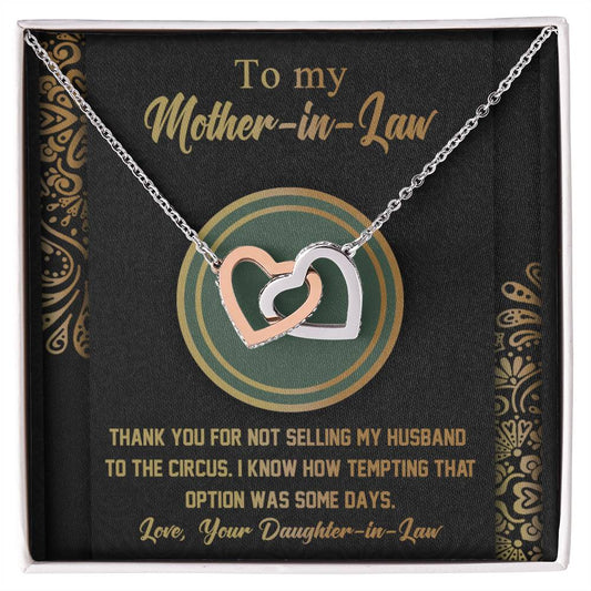 A unique gift, the To Mother-In-Law, Thank You - Interlocking Hearts Necklace with intertwined heart pendants adorned with cubic zirconia crystals, comes inside a box that includes a humorous message to a mother-in-law, expressing gratitude humor