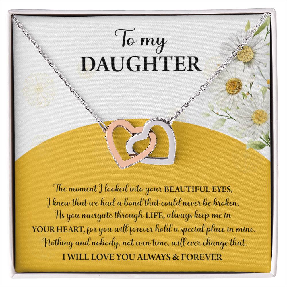 A box contains a "To Daughter, A Special Place - Interlocking Hearts Necklace" with cubic zirconia crystals. The message reads: "To my Daughter... Always keep me in your heart... Nothing brings me more joy than you. I will love you always & forever.