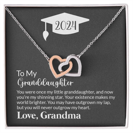 A graduation-themed ShineOn Fulfillment Cubic Zirconia necklace with an interlocking hearts design, presented in a gift box with a sentimental message to a granddaughter from her grandmother.