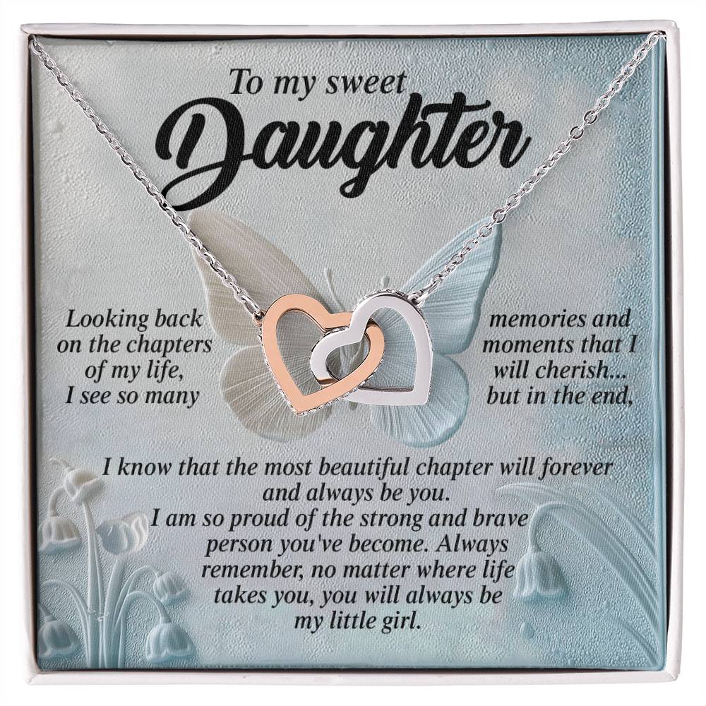 A square card for a daughter, featuring a heartfelt message and the Daughter-Beautiful Chapter - Interlocking Hearts Necklace with interlocked gold and silver infinity symbols, sits against a butterfly background highlighted by delicate cubic zirconia crystals for an elegant touch.