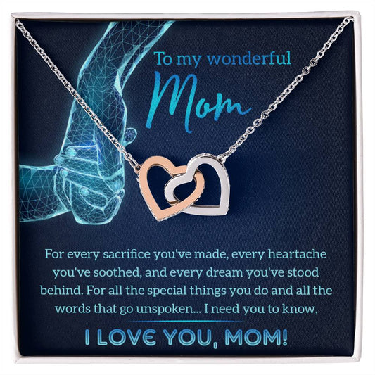 An "To Mom, Stood Behind - Interlocking Hearts Necklace" with cubic zirconia crystals and a touching message dedicated to "mom" presented in a gift box.