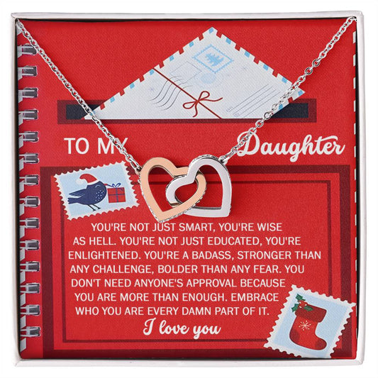 The Daughter-Part Of It - Interlocking Hearts Necklace features a rose gold finish embellished with cubic zirconia crystals, elegantly displayed on a red card that reads "To my daughter" along with an inspirational message, surrounded by festive Christmas graphics. This piece beautifully combines elegance and heartfelt sentiment.