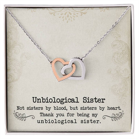 Silver necklace with the To My Unbiological Sister, Sister By Heart - Interlocking Hearts Necklace pendants inlaid with cubic zirconia crystals on a message card for an "unbiological sister" by ShineOn Fulfillment.