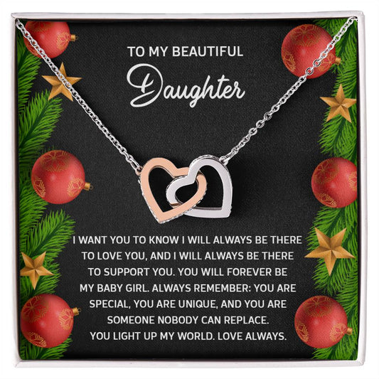 Presenting the "Daughter-Nobody Can Replace" Interlocking Hearts Necklace, featuring a breathtaking rose gold finish. It comes on a black card with a heartfelt message to your daughter and is embellished with holiday ornaments, lush greenery, and dazzling cubic zirconia crystals.