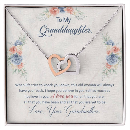 A heart-shaped pendant necklace, featuring interlocking hearts adorned with cubic zirconia crystals, on a display card with an affectionate message from ShineOn Fulfillment to her granddaughter.