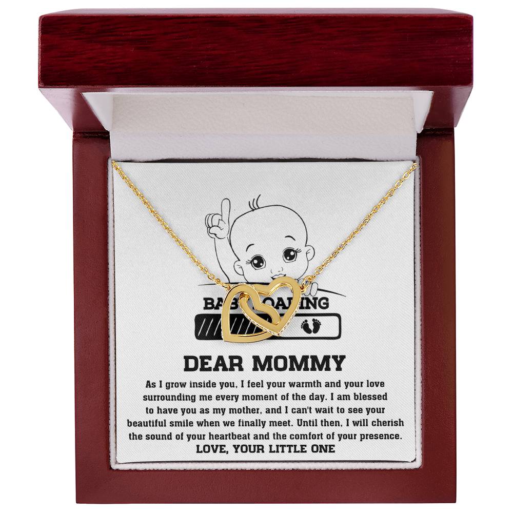 ShineOn Fulfillment's To Mama To Be, Your Little One - Interlocking Hearts Necklace with baby footprint and "dear mommy" inscription in a red jewelry box with a sentimental message to a mother from her unborn child, enhanced with cubic zirconia crystals