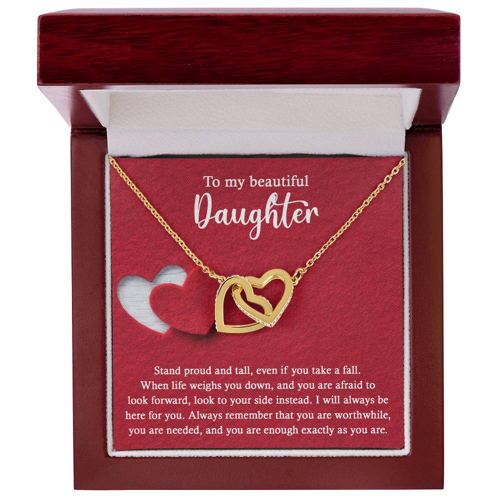 Introducing the elegant "To Daughter, As You Are 2 - Interlocking Hearts Necklace." This stunning piece features two intertwined hearts set against a red background and adorned with sparkling cubic zirconia crystals. The pendant holds the heartfelt message: "To my beautiful Daughter. Stand proud and tall, even if you take a fall..." Crafted from durable surgical steel, this necklace is designed to be both beautiful and enduring.