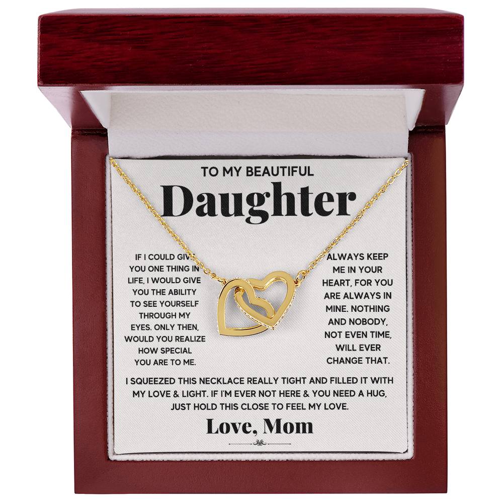 A necklace with a "To My Beautiful Daughter, Just Hold This To Feel My Love" - Interlocking Hearts Necklace pendant in a gift box featuring a sentimental message from ShineOn Fulfillment to a daughter.