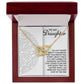 A gold "Daughter-Tomorrow Worry - Interlocking Hearts Necklace" with rose gold finish is showcased in an open wooden box, which has a heartfelt message inside for a daughter, highlighting love, support, and resilience.
