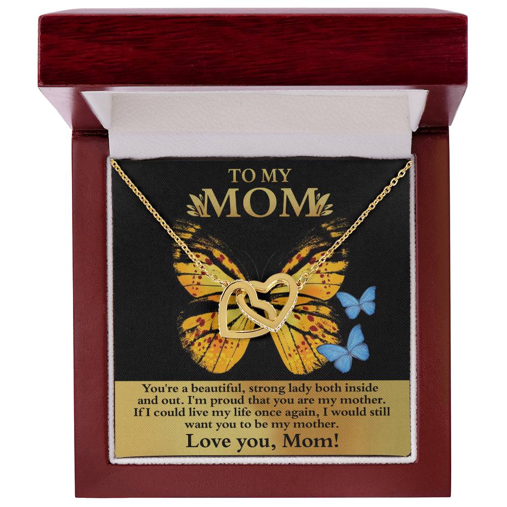 The "[Almost Sold Out] To Mom, Strong Lady - Interlocking Hearts Necklace" in gold is adorned with cubic zirconia crystals. It arrives in a box with a butterfly-themed card reading "To My Mom" and a heartfelt message, making it the perfect gift.