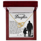 The Daughter-Smile More Interlocking Hearts Necklace, adorned with cubic zirconia crystals, is in a red box with a lid showing a heartfelt message from a dad to his daughter and their silhouette holding hands.