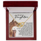 A wooden jewelry box with an open lid showcases the Daughter-Never Alone Interlocking Hearts Necklace in 18k yellow gold. Inside, it features illustrations of two cats and a loving message starting with "To My Daughter," conveying love and encouragement.