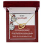 The Granddaughter-To An End - Interlocking Hearts Necklace, adorned with cubic zirconia crystals, is thoughtfully presented in a red jewelry box and includes a touching message about love and cherished memories for a granddaughter.